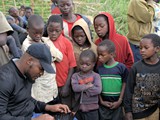 kids_watching_supervisor_recording_fish_data